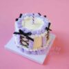 Midnight Elegance: Mini Cake Wrapped in Purple and Black Charms